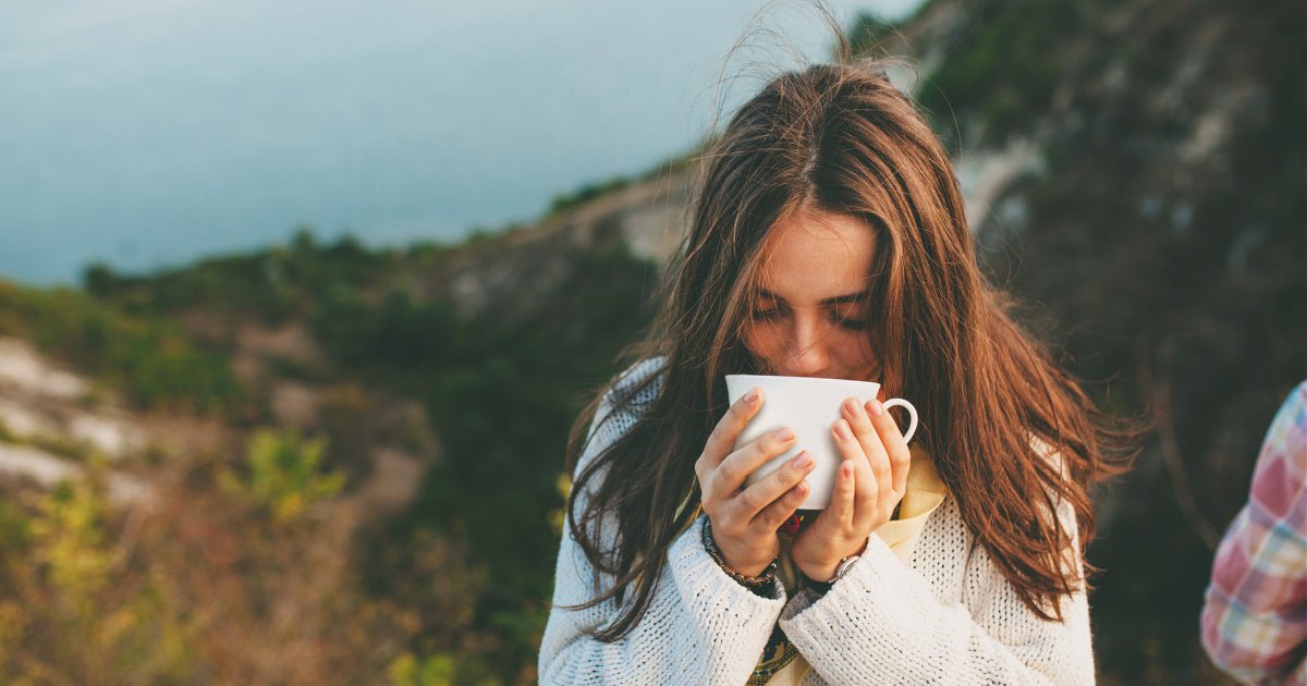 Woman drinking tea outside as one of her self-care ideas