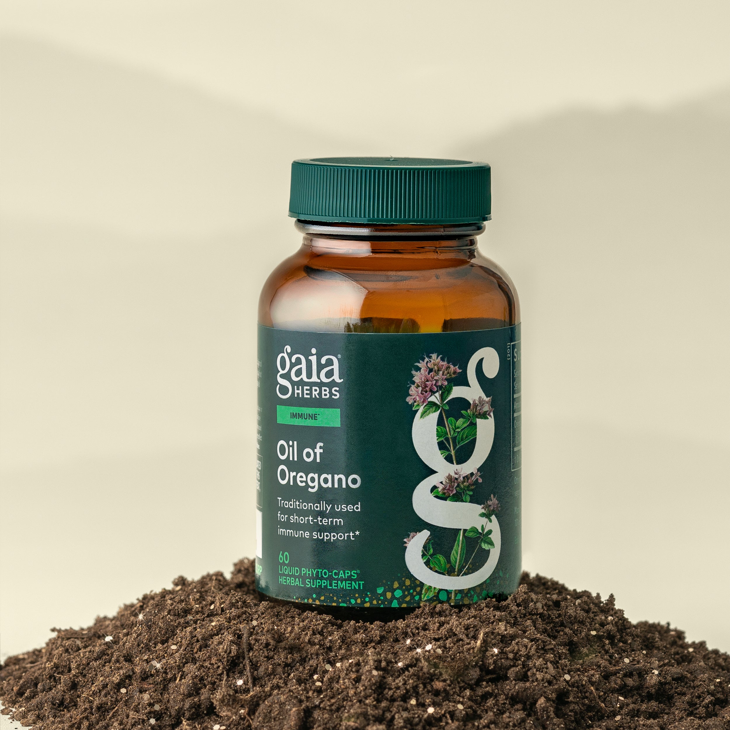 Gaia Herbs Oil of Oregano supplement bottle on a soil background