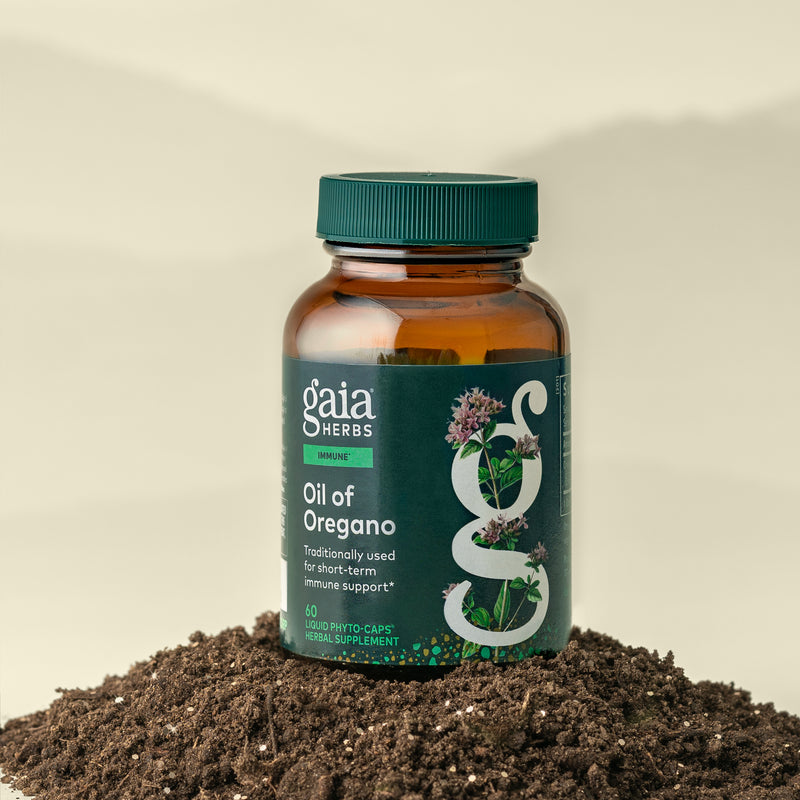 Gaia Herbs Oil of Oregano supplement bottle on a soil background
