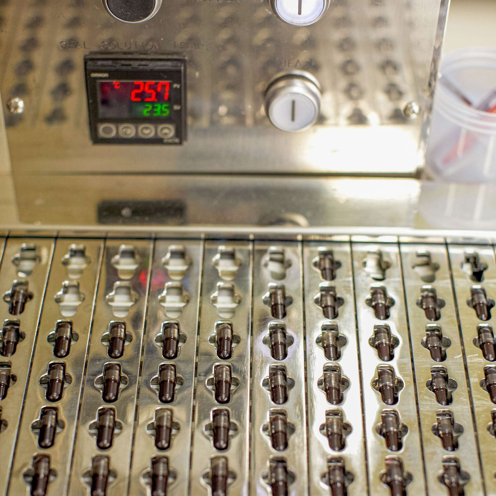 Metallic appliance with control panel and multiple nozzles