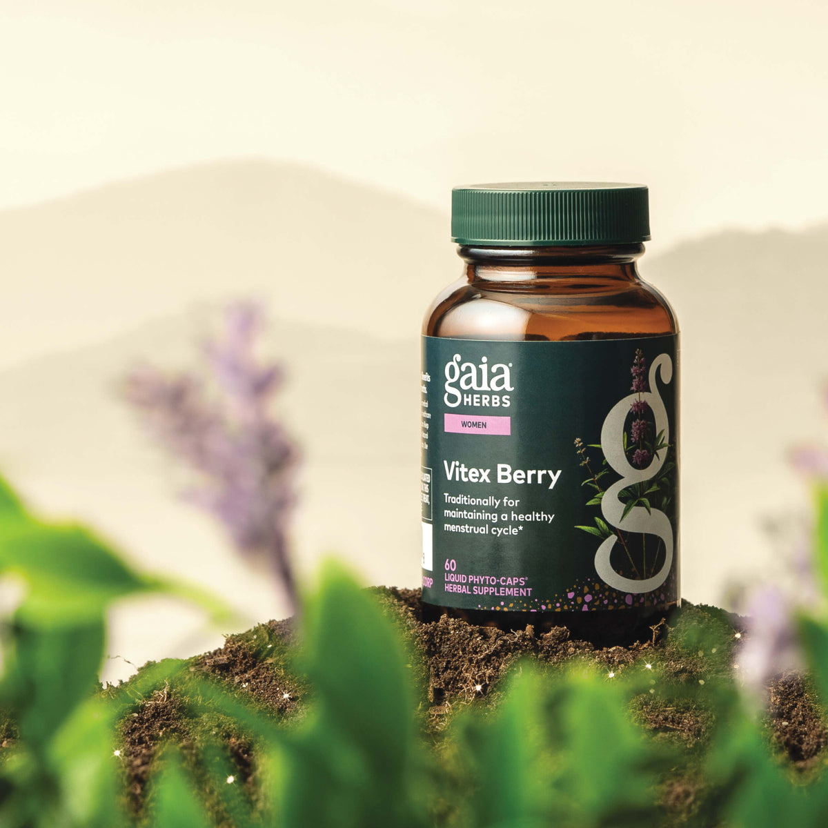 Gaia Herbs Vitex Berry 60 count supplement bottle on a natural background with plants and flowers.