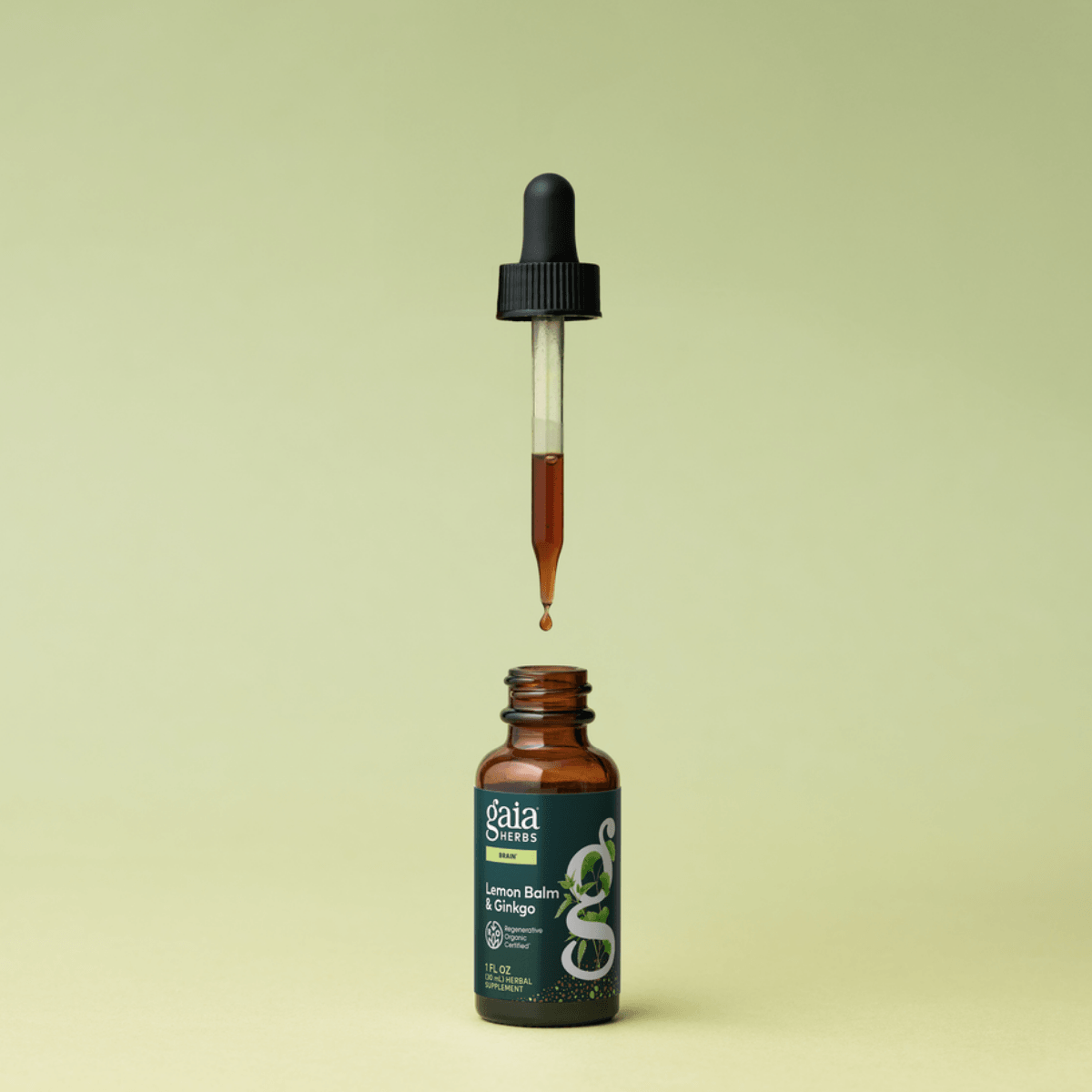Gaia Herbs Lemon Balm & Ginkgo tincture with dropper on a light green background