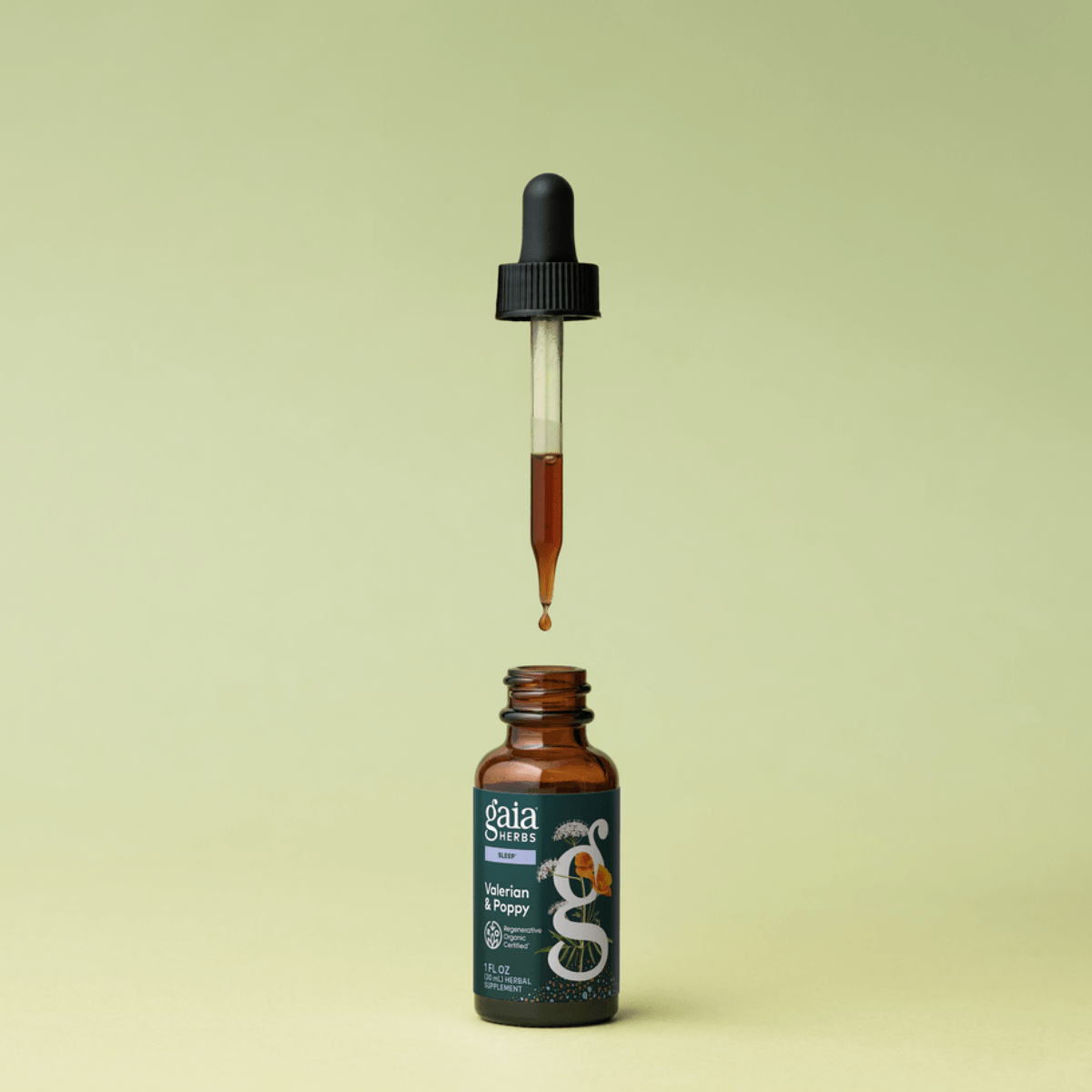 Gaia Herbs Valerian & Poppy tincture bottle with dropper on a light green background